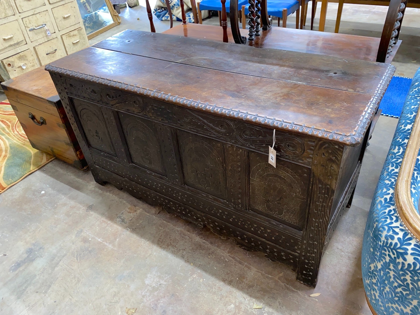 A 17th century carved oak coffer with adapted top, length 142cm, depth 56cm, height 76cm